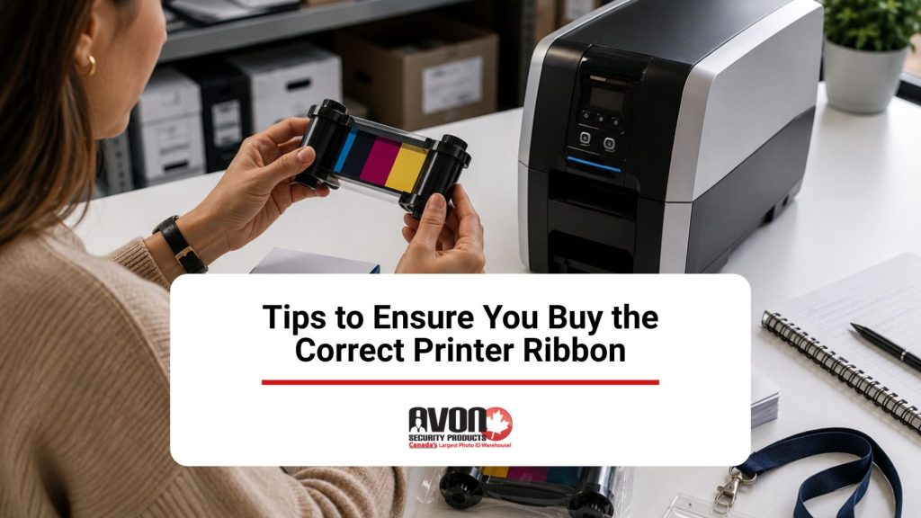 Woman comparing an ID card printer ribbon with a desktop card printer to ensure the correct ribbon is selected.