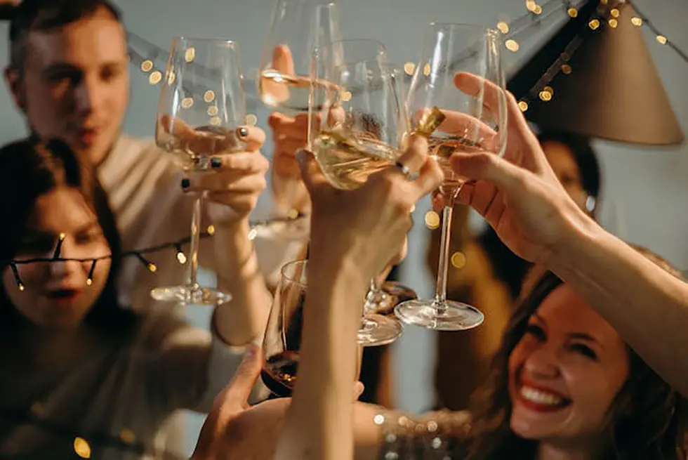 A group of friends raising their glasses, celebrating