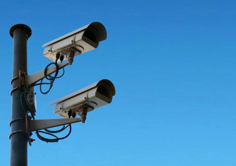 CCTV cameras on a pole with blue sky behind