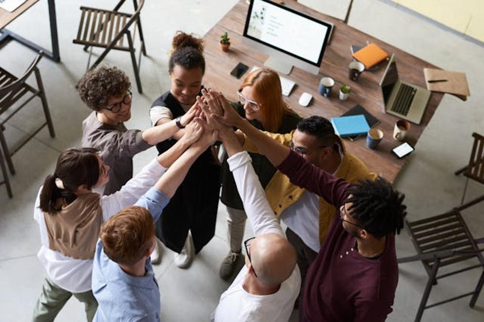 team at work putting their hands together in a huddle
